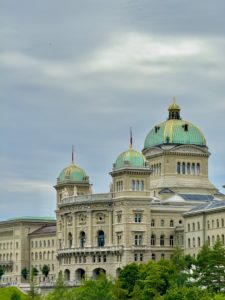 A large building with a green dome on top of it